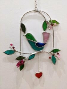 Bluebird on swing with hanging heart, stained glass by Clair-J Napier-McDonald